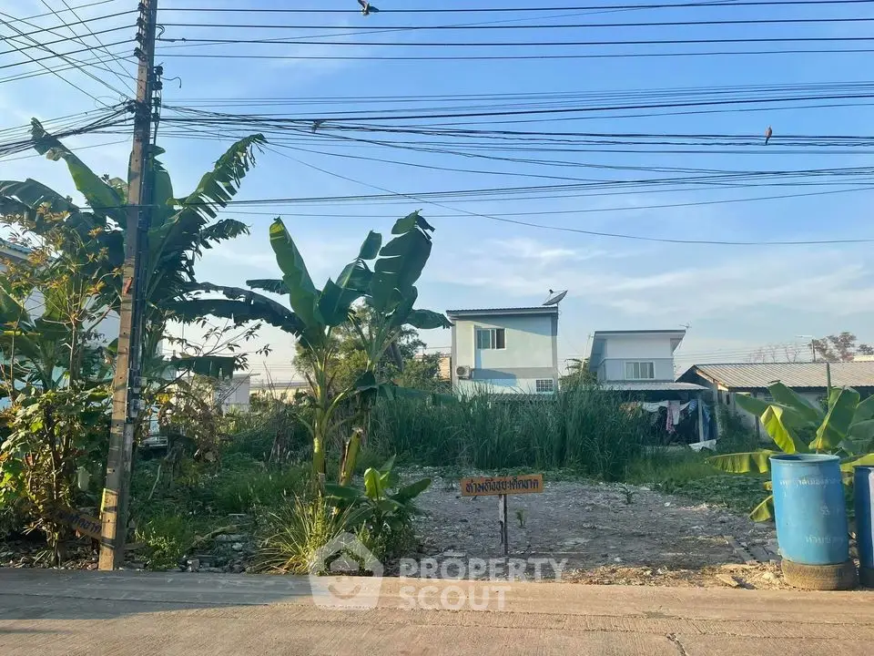 Vacant land with potential for development in a residential area, surrounded by greenery and modern homes.