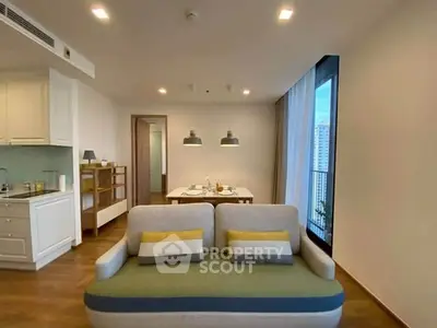 Modern living room with cozy sofa and dining area in open layout apartment