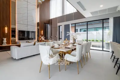 Luxurious modern living and dining area with elegant decor and large windows.