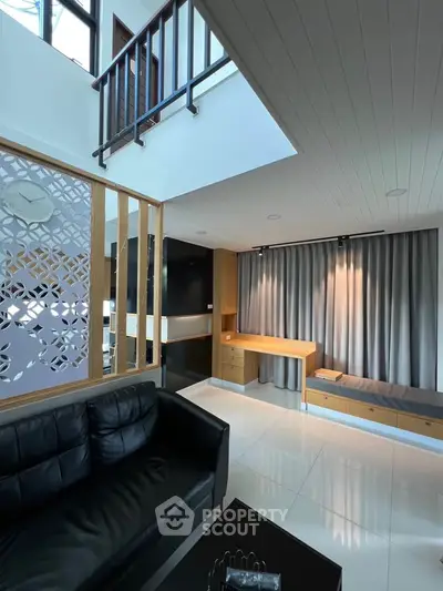 Modern living room with sleek design, high ceiling, and stylish furniture in a contemporary home.