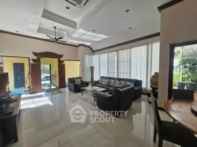 Spacious living room with modern decor and large windows offering natural light.