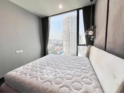 Spacious bedroom with stunning city view in modern high-rise apartment