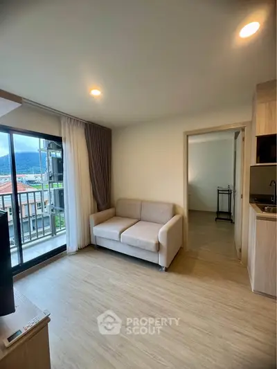 Modern living room with cozy sofa and balcony view in a stylish apartment.