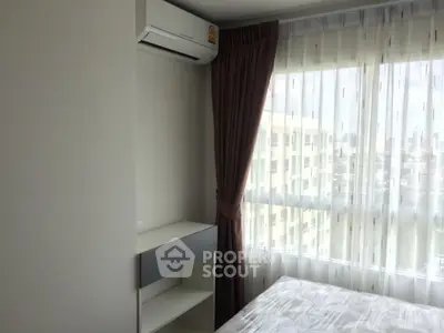 Bright bedroom with large window and air conditioning in modern apartment