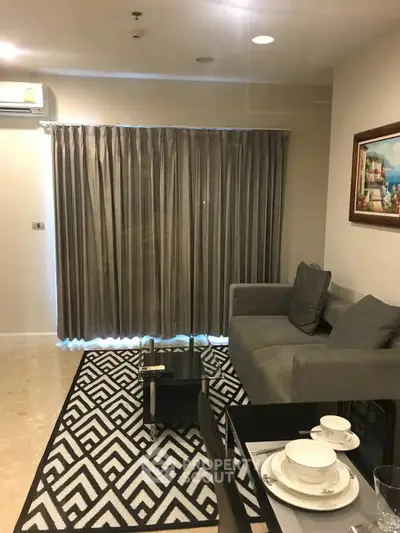 Cozy living room with modern decor and elegant curtains in a stylish apartment.