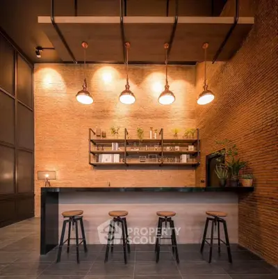 Stylish modern kitchen with brick walls and elegant lighting, perfect for entertaining.