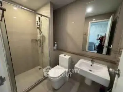 Modern bathroom with glass shower and sleek fixtures