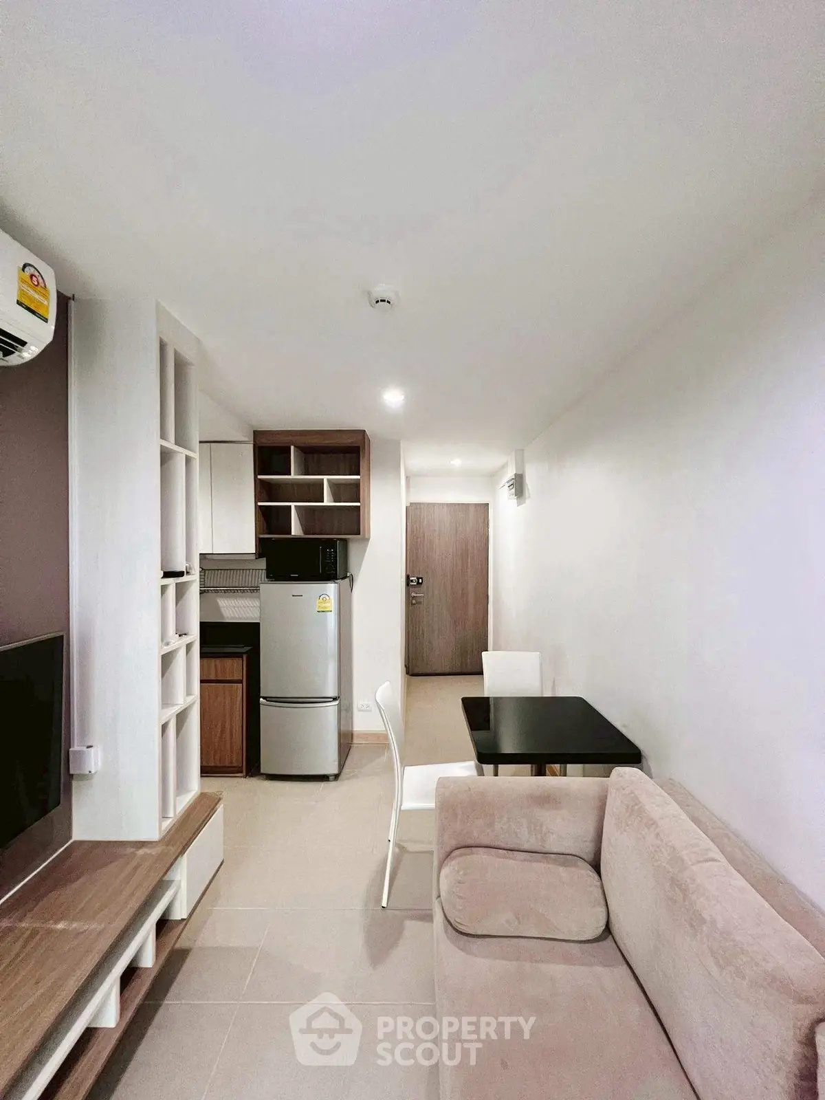 Modern apartment with cozy living room and compact kitchen, ideal for urban living.