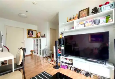 Modern living room with large TV and stylish shelving unit