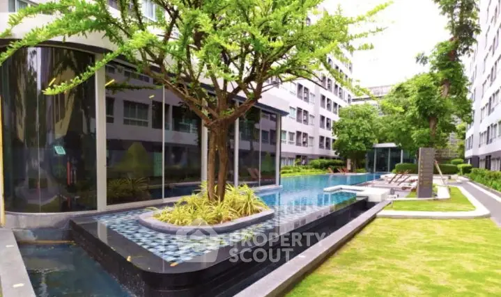Luxurious residential pool area with modern landscaping and lush greenery.