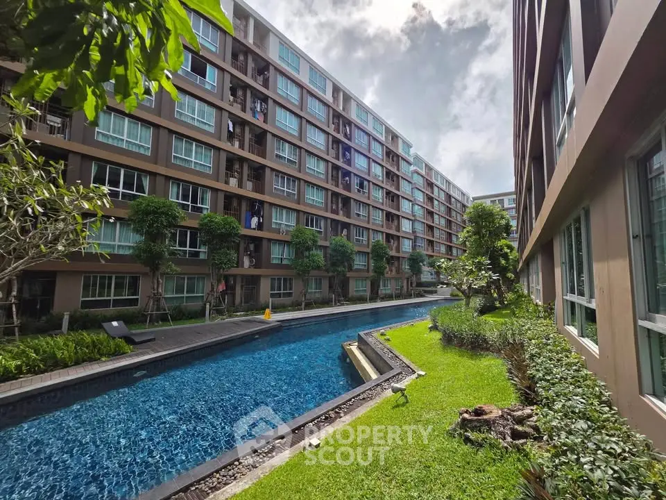 Modern condominium with lush garden and inviting swimming pool, perfect for urban living.