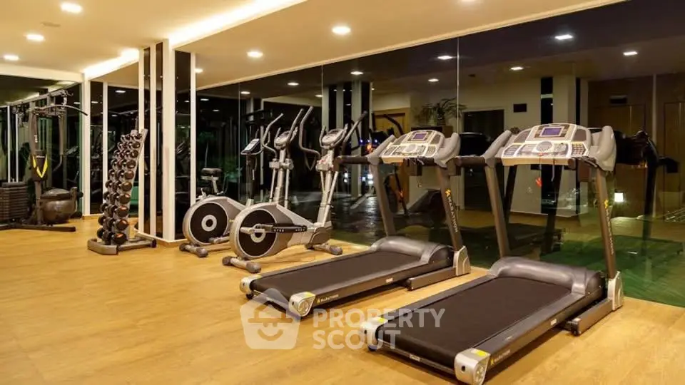 Modern gym with state-of-the-art equipment in luxury residential building.