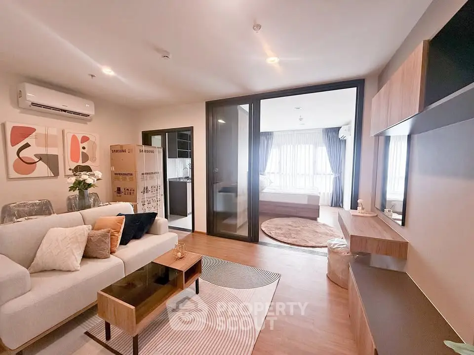 Modern living room with stylish decor and open view to bedroom