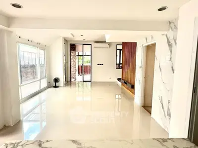 Spacious modern living room with marble accents and large windows