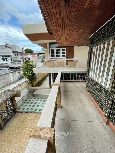 Spacious balcony with modern design and city view, perfect for relaxation and entertaining guests.