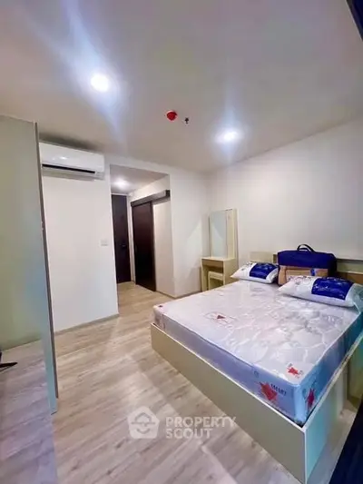 Modern bedroom with sleek design and ample lighting in a contemporary apartment.