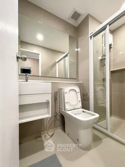 Modern bathroom with sleek fixtures and glass shower enclosure