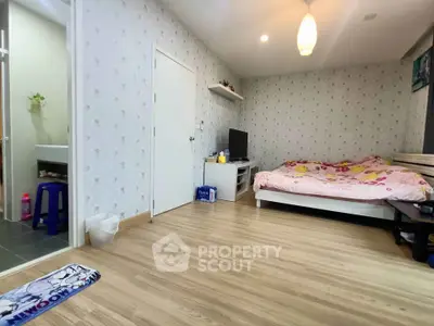 Cozy bedroom with wooden flooring and modern decor