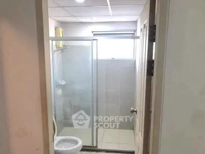 Compact bathroom with shower and toilet in modern apartment