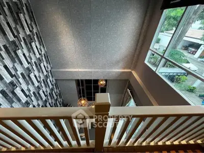 Stunning loft view with modern design and large windows overlooking outdoor scenery.