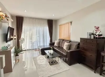 Stylish living room with modern decor and large window for natural light.