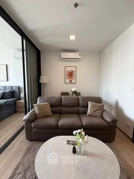 Modern living room with cozy sofa and stylish decor in a contemporary apartment.