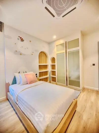 Charming bedroom with cozy single bed and playful wall art, perfect for a child's room.