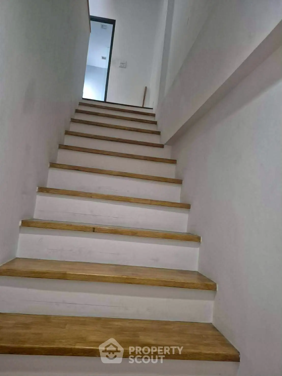 Modern wooden staircase with sleek design in a contemporary home interior.