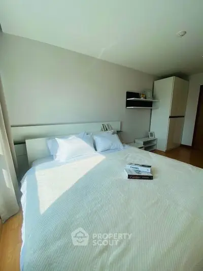 Bright and cozy bedroom with modern decor and ample natural light.