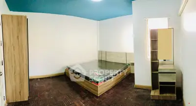 Spacious bedroom with modern wooden furniture and natural light