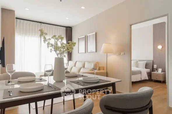 Modern open-plan living and dining area with elegant decor and natural light.