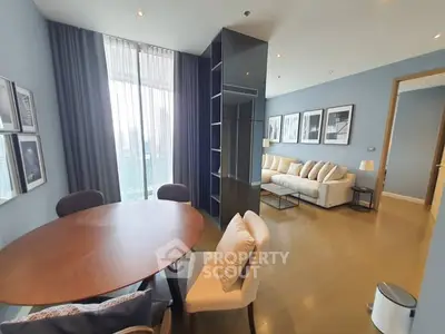 Modern living room with elegant decor and large windows for natural light.