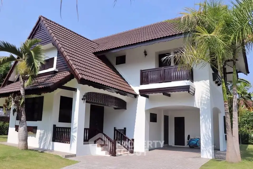 Charming two-story house with tropical landscaping and spacious driveway