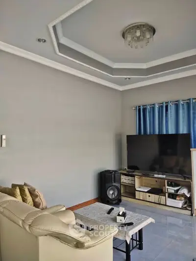 Modern living room with elegant ceiling design and cozy seating area