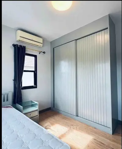 Cozy bedroom with built-in wardrobe and air conditioning, perfect for comfortable living.