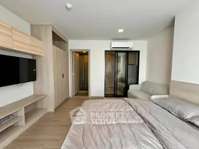Modern bedroom with sleek design, featuring a cozy bed, built-in wardrobe, and wall-mounted TV for ultimate comfort.