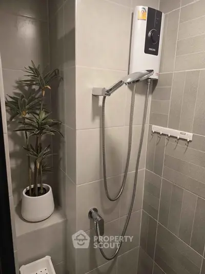 Modern bathroom with sleek shower and stylish plant decor