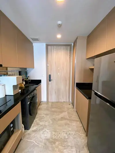 Modern kitchen with sleek cabinetry and built-in appliances in a stylish apartment.