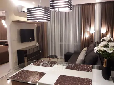 Modern living room with stylish lighting and elegant decor, featuring a cozy sofa and dining area.