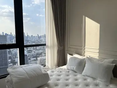 Luxurious bedroom with stunning city view from large windows, elegant curtains, and plush bedding.