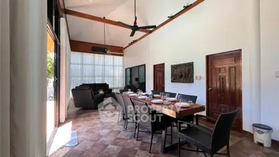 Spacious dining area with high ceilings and elegant decor in a modern home.