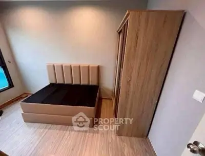 Cozy bedroom with modern bed and wooden wardrobe, perfect for relaxation.
