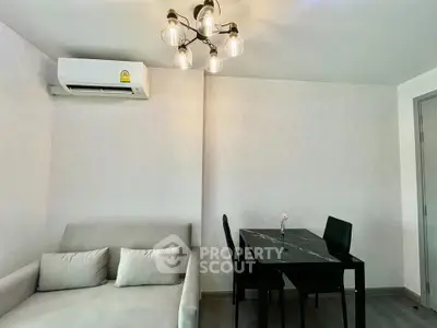 Modern living room with chic lighting and cozy dining area in a stylish apartment.