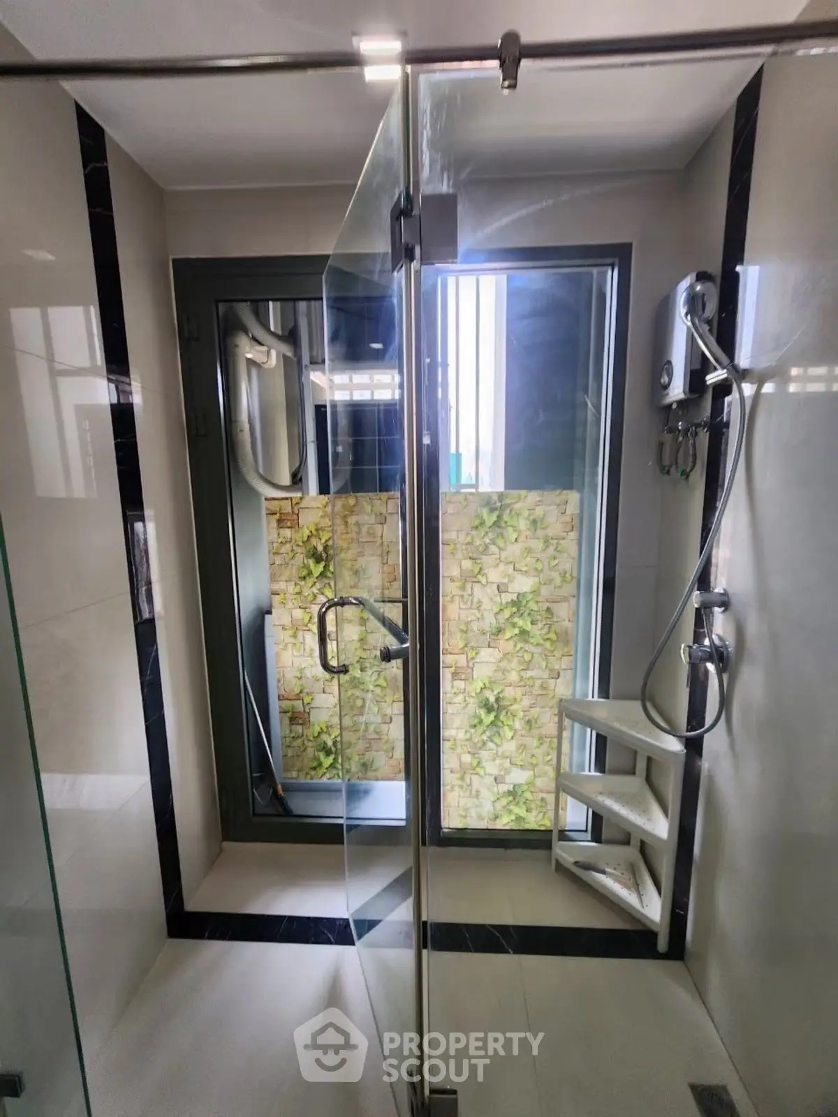 Modern bathroom with glass shower enclosure and stylish wall tiles