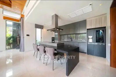 Luxurious modern kitchen with sleek design and high-end appliances in a spacious open layout.