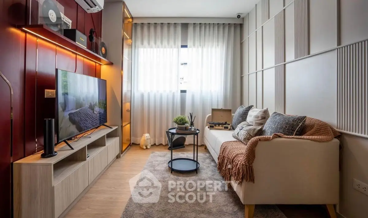 Stylish living room with modern decor, cozy sofa, and entertainment setup.