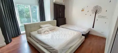 Spacious bedroom with large bed and wall art in modern apartment