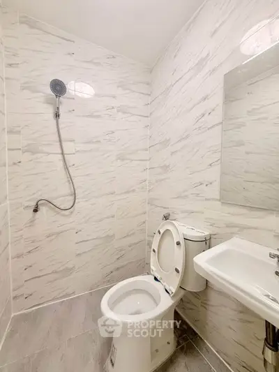 Modern bathroom with sleek white tiles and minimalist fixtures