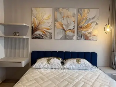 Elegant bedroom with modern art and cozy lighting, featuring a plush bed and stylish decor.