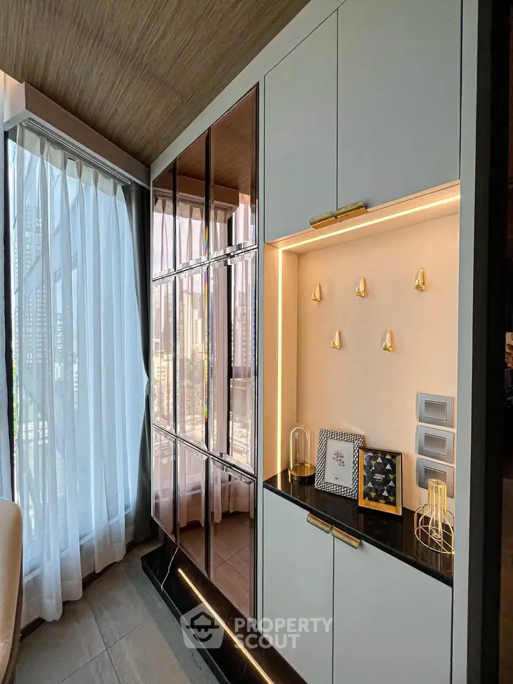 Luxurious modern living room with floor-to-ceiling windows and elegant cabinetry in a high-rise apartment.